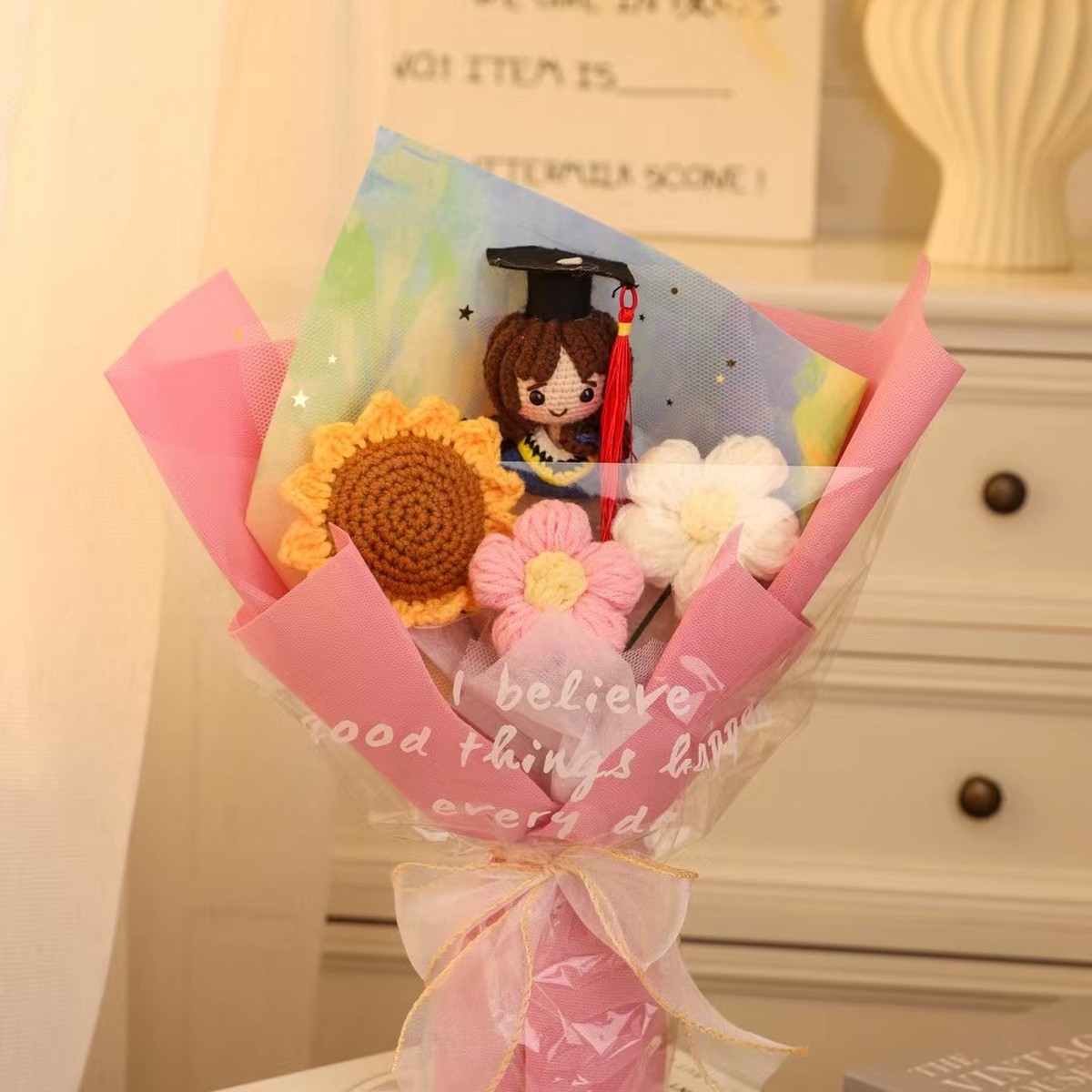 Pink Graduation Crochet Flower Bouquet centered in a clean lifestyle product photograph