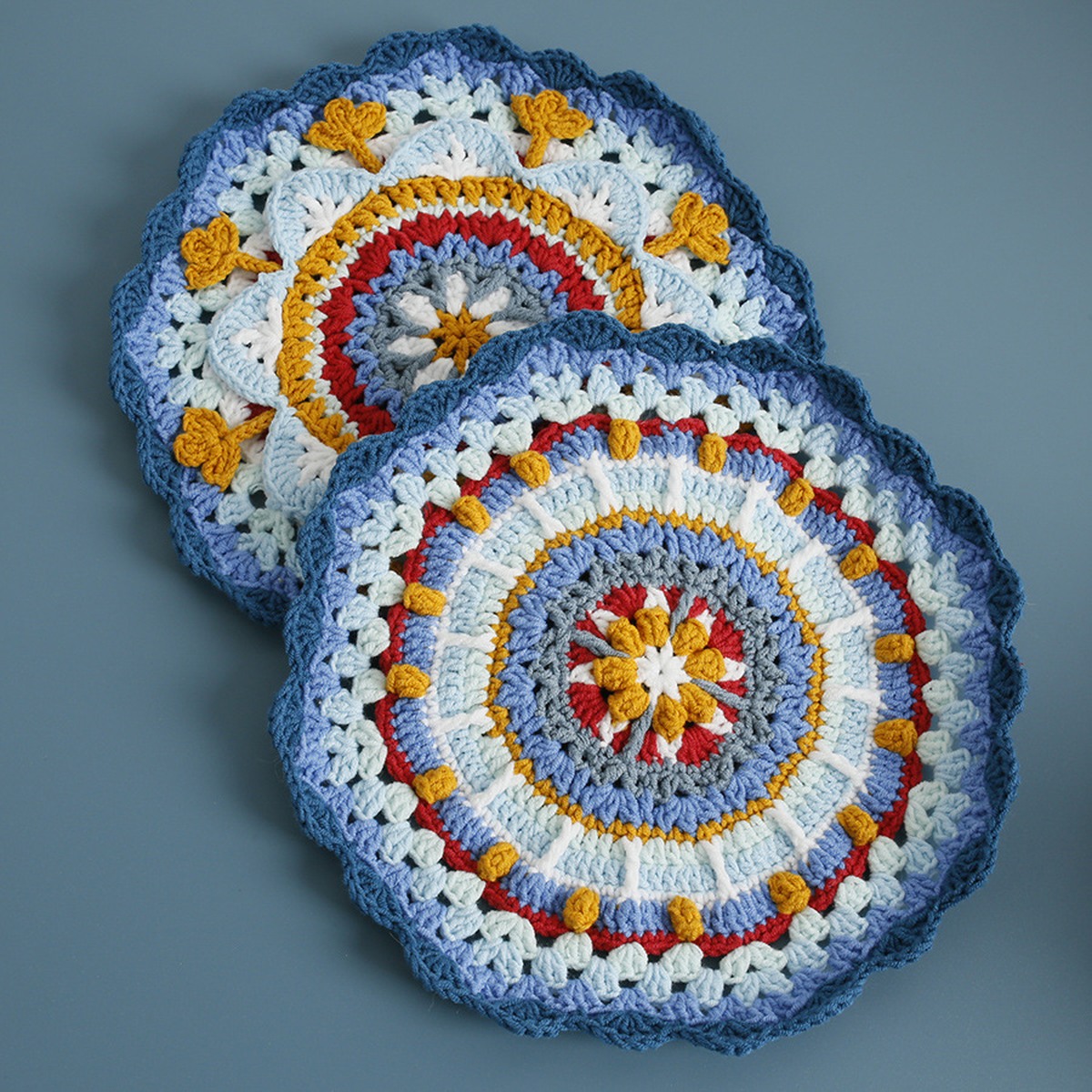 Blue Sunburst Crochet Coaster Set centered on a clean product background