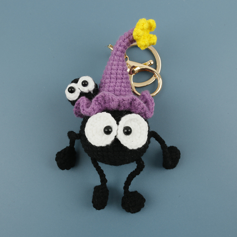 Original black crochet spider keychain wearing a purple witch hat