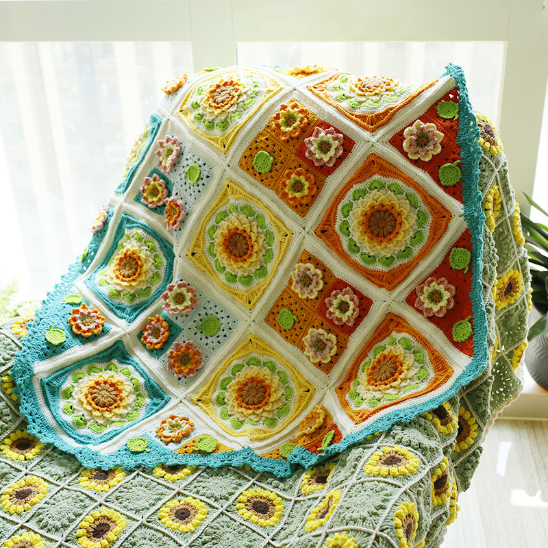 Colorful handmade floral patchwork crochet blanket draped in a bright interior