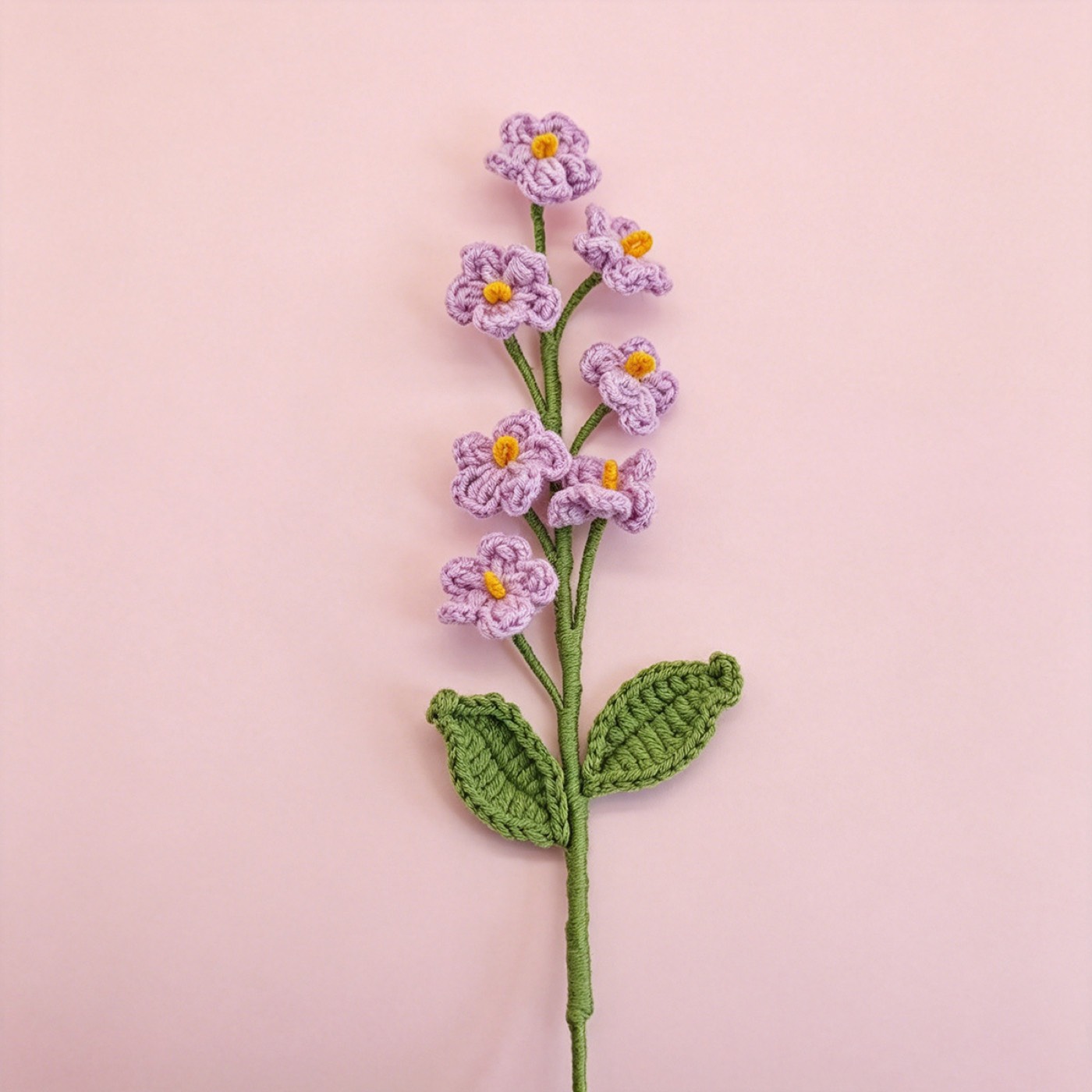 Forget-Me-Not Crochet Stem on a clean pastel product background